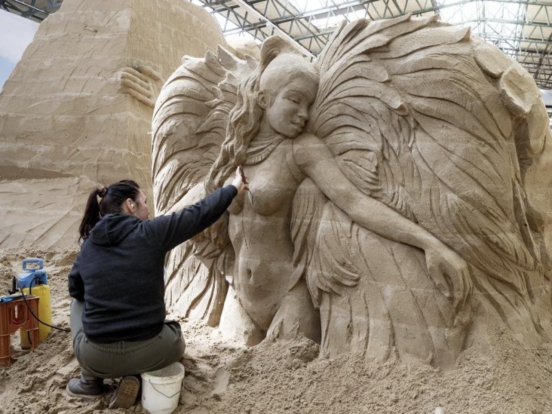 Die ukrainische Künstlerin Iryna Kalyuzhna arbeitet an ihrer Sandskulptur «Brasilien». Die Sandskulpturenausstellung «Reise um die Welt» eröffnet am 07. Mai und dauert bis Ende Oktober. Foto: Markus Scholz/dpa