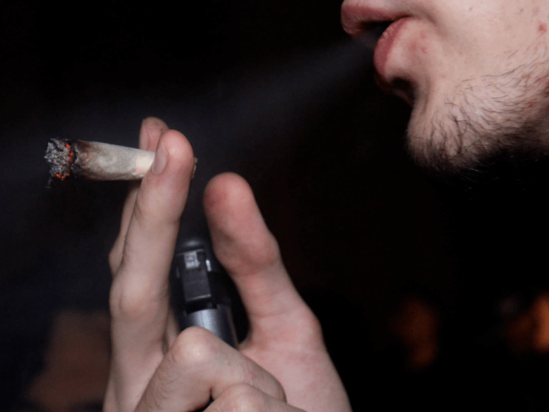 Ein Mann zieht an einem Cannabis-Joint. (Symbolbild)